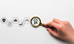 Quality research concept with thematic icons. Hand holds a magnifying glass