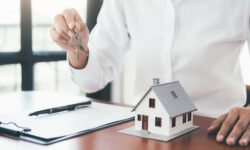 House model with real estate agent and customer discussing for contract to buy house, insurance or loan real estate background.